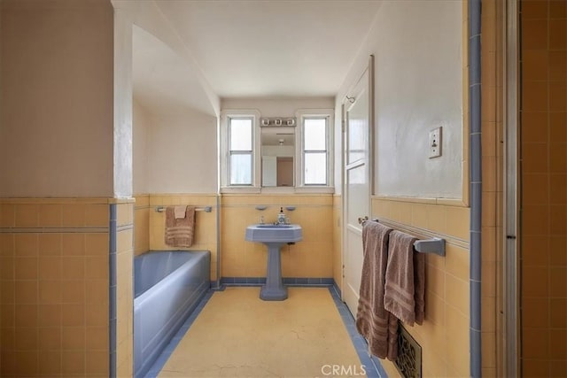 bathroom with separate shower and tub and tile walls