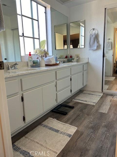 bathroom with hardwood / wood-style floors and vanity