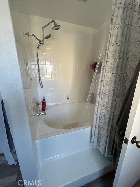 bathroom with shower / bath combination with curtain