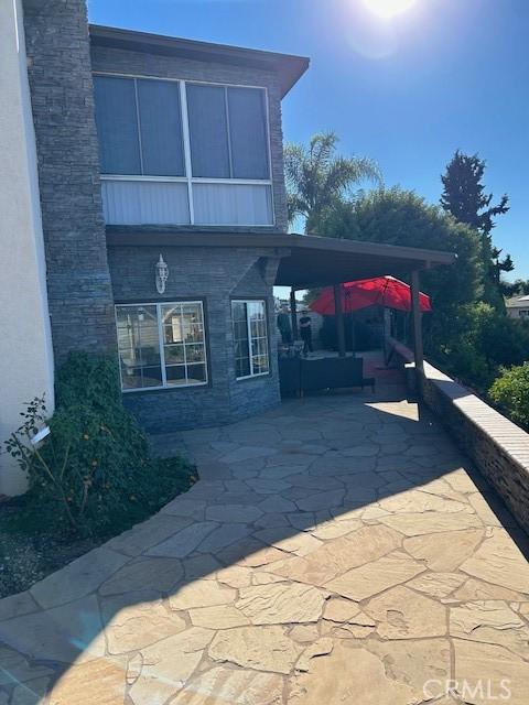 view of home's exterior with a patio area and a carport