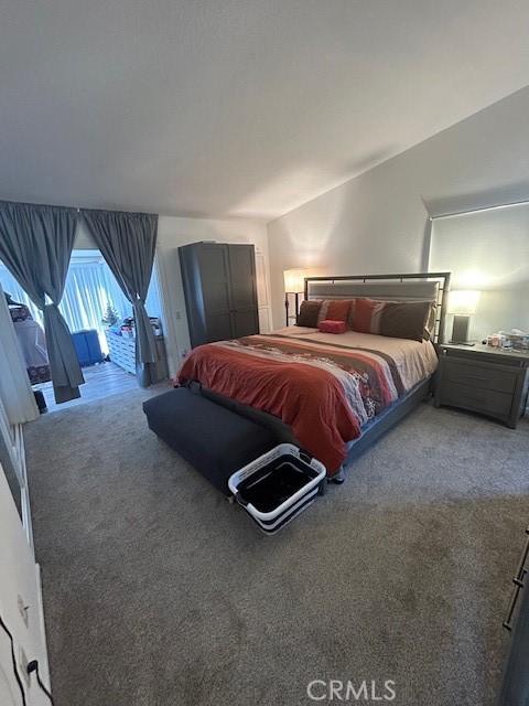 carpeted bedroom featuring access to outside and vaulted ceiling