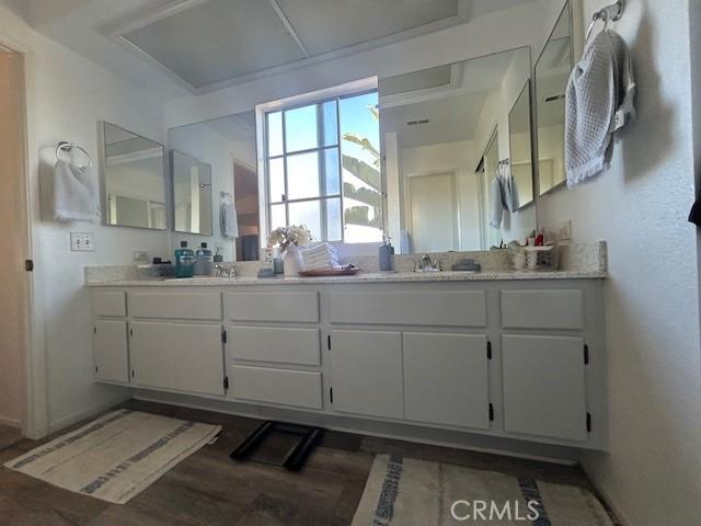 bathroom with vanity and hardwood / wood-style flooring