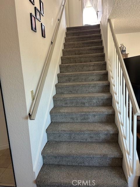 stairs featuring tile patterned flooring