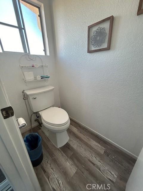 bathroom with wood-type flooring and toilet