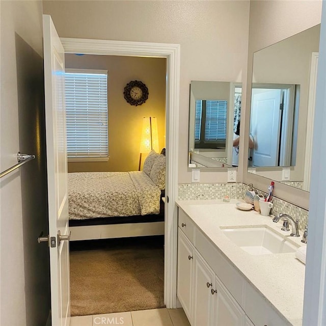 bedroom with light colored carpet and sink