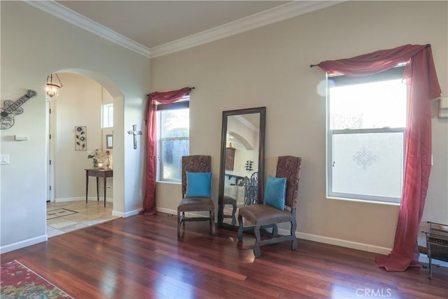 sitting room with dark hardwood / wood-style flooring and crown molding