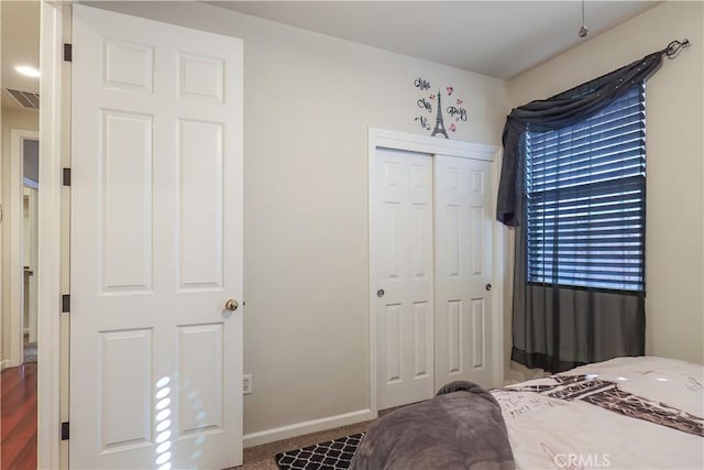 carpeted bedroom featuring a closet