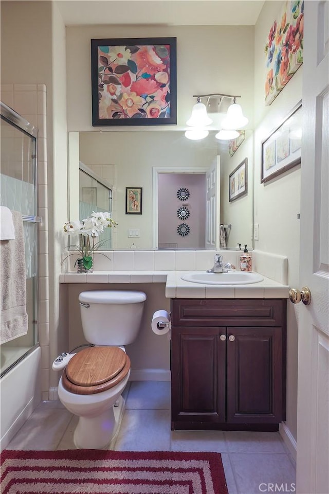 full bathroom featuring tile patterned floors, vanity, enclosed tub / shower combo, and toilet