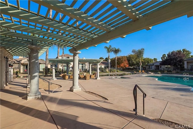 view of pool with a pergola and a patio