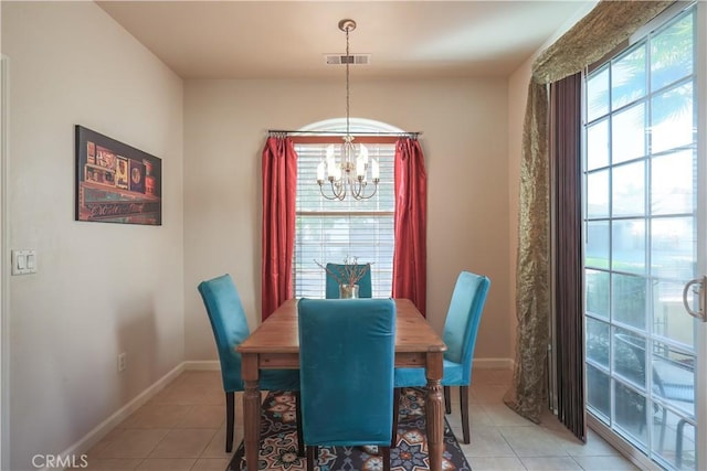 tiled dining area with a chandelier