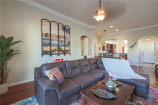 living room featuring ceiling fan, dark hardwood / wood-style flooring, and ornamental molding