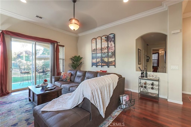 living room with dark hardwood / wood-style floors and crown molding