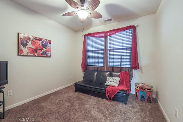 living area featuring ceiling fan and carpet