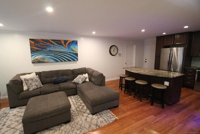 living room featuring crown molding and hardwood / wood-style flooring