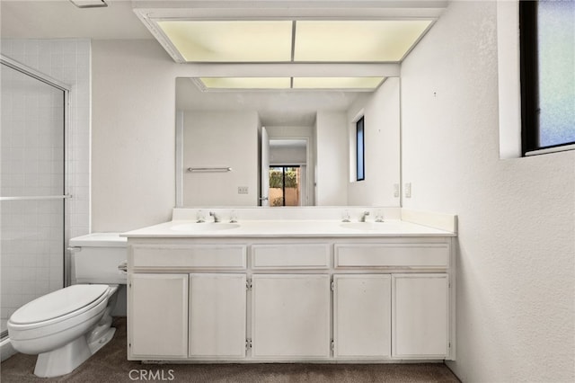 bathroom featuring vanity, toilet, and an enclosed shower