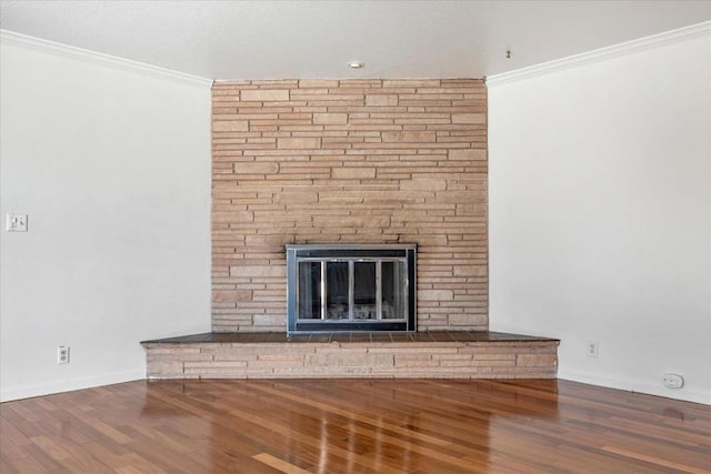 unfurnished living room with hardwood / wood-style flooring, crown molding, and a fireplace