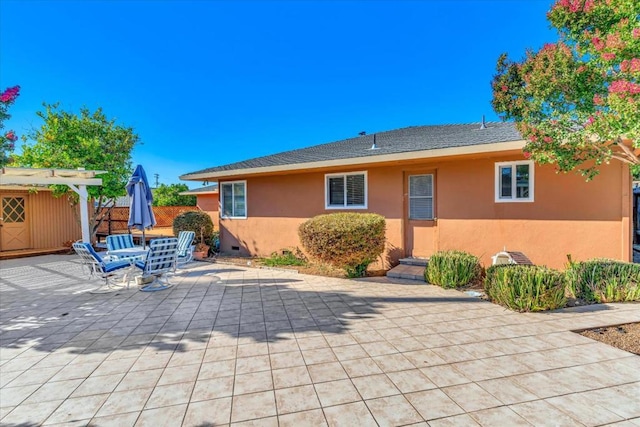 back of property with a patio