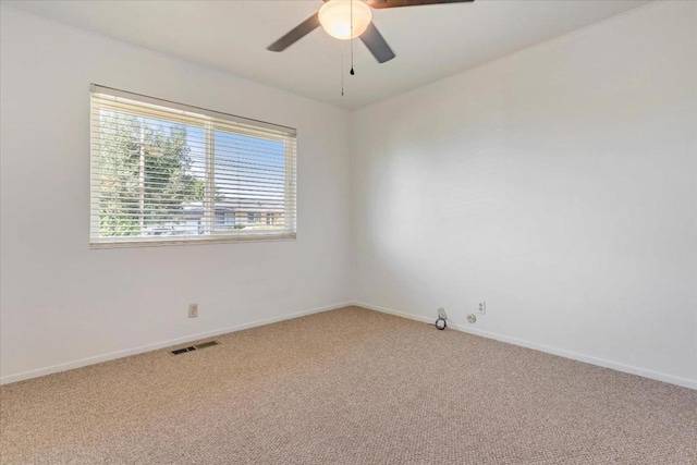 carpeted spare room with ceiling fan