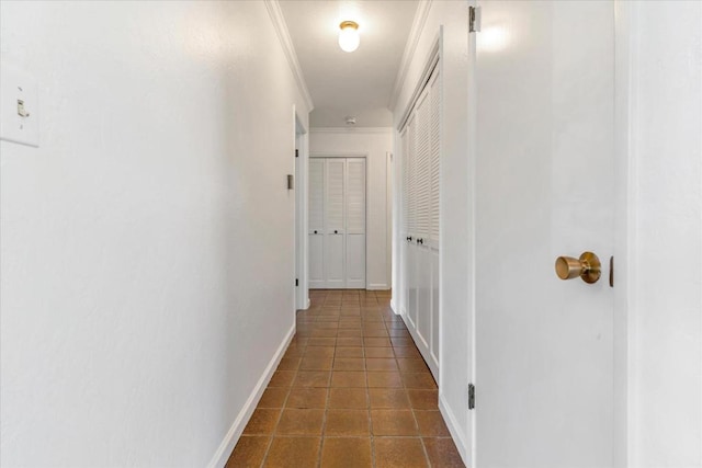 hall featuring crown molding and dark tile patterned floors