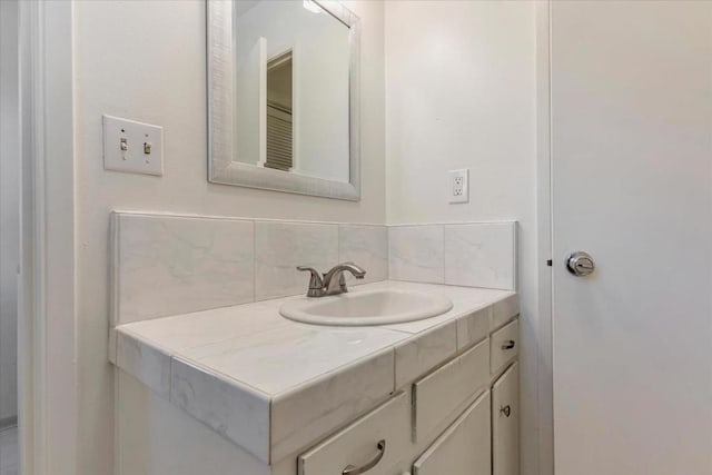 bathroom with tasteful backsplash and vanity