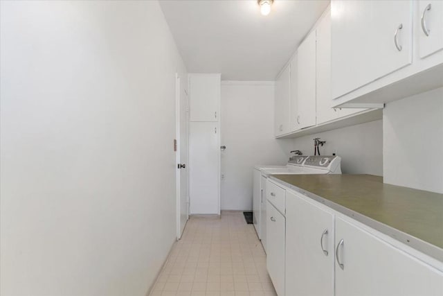 washroom with cabinets and independent washer and dryer