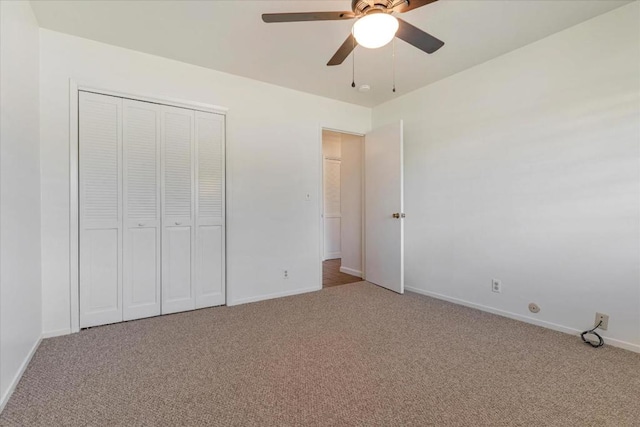 unfurnished bedroom featuring ceiling fan, a closet, and carpet flooring