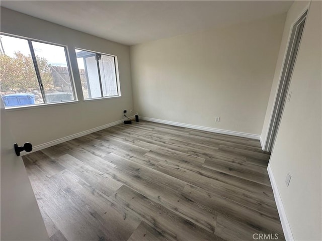 unfurnished room with hardwood / wood-style floors