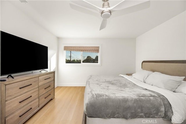 bedroom with ceiling fan and light hardwood / wood-style floors