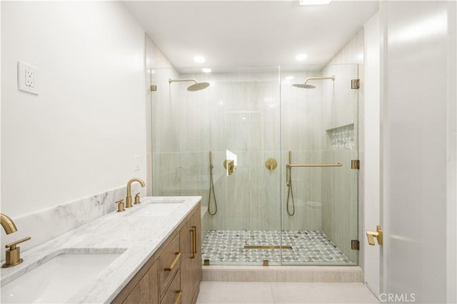 bathroom featuring tile patterned floors, walk in shower, and vanity