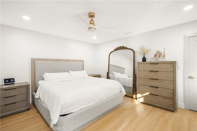 bedroom with ceiling fan and light wood-type flooring