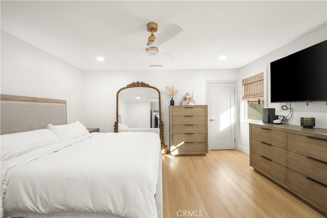 bedroom with ceiling fan and light hardwood / wood-style flooring