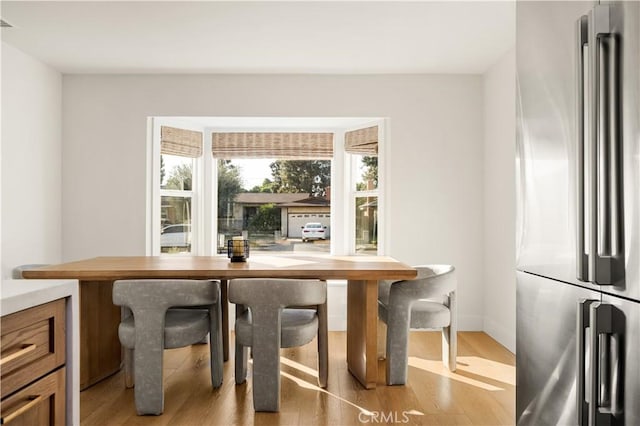 dining space with light hardwood / wood-style floors