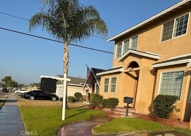 view of property exterior featuring a lawn