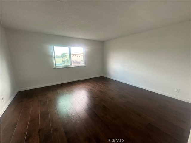 unfurnished room featuring dark hardwood / wood-style flooring