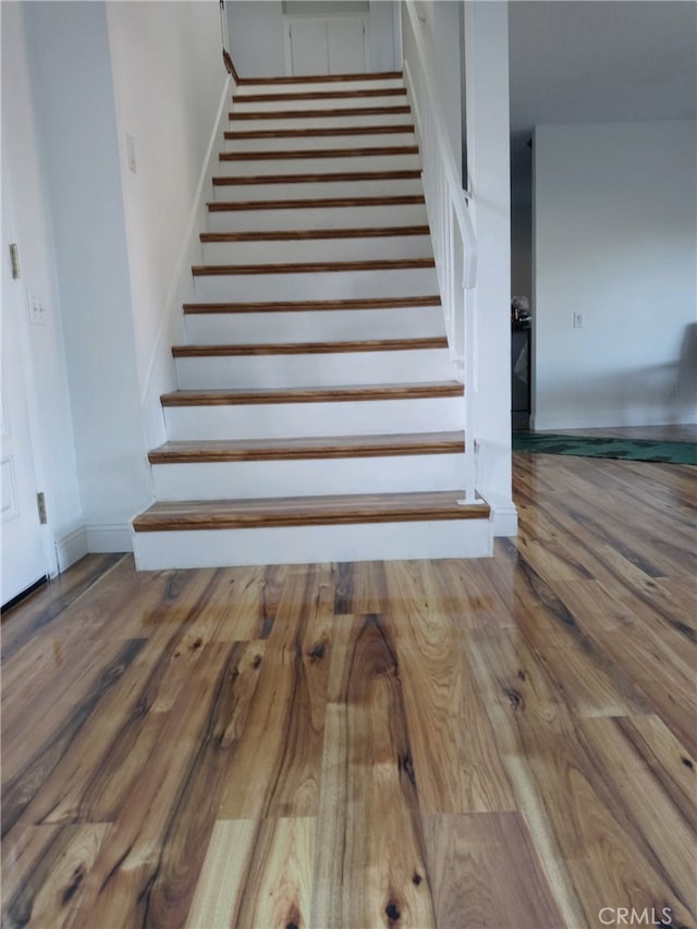 stairway featuring hardwood / wood-style flooring