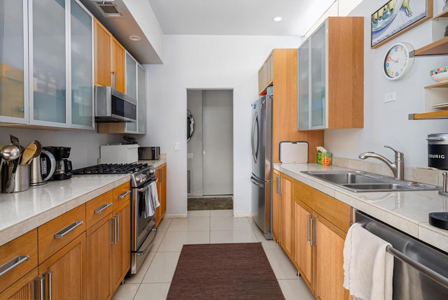 kitchen featuring sink, light tile patterned floors, and appliances with stainless steel finishes