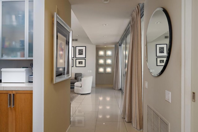 hall with light tile patterned floors