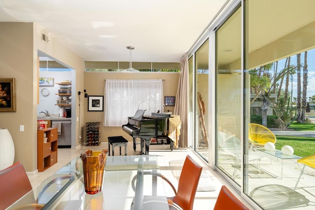 interior space with light tile patterned floors and sink