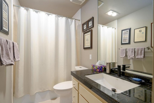 bathroom with tile patterned flooring, vanity, and toilet