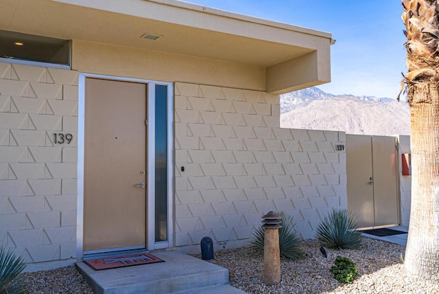 view of exterior entry featuring a mountain view