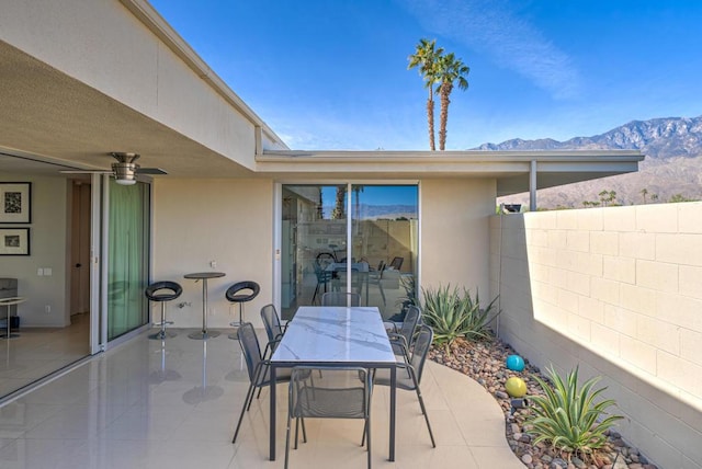 view of patio / terrace featuring a mountain view and ceiling fan