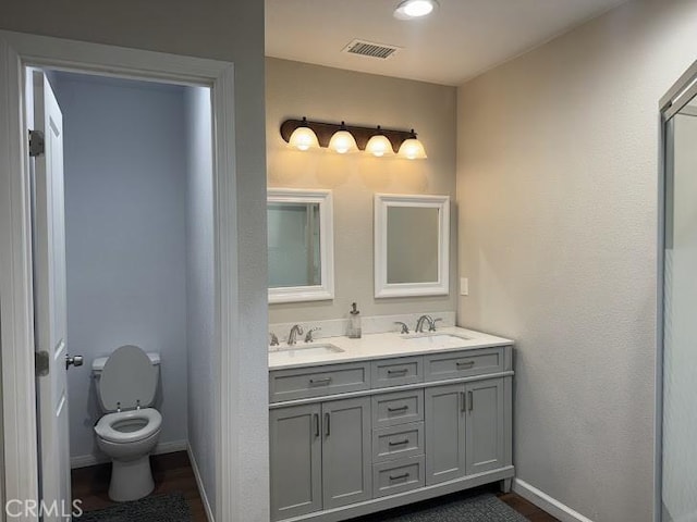 bathroom with vanity and toilet