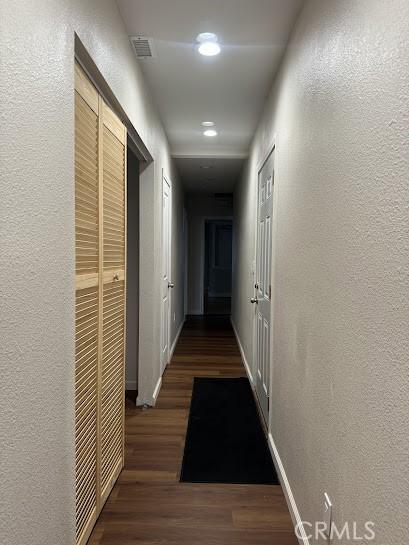 hallway with dark hardwood / wood-style flooring