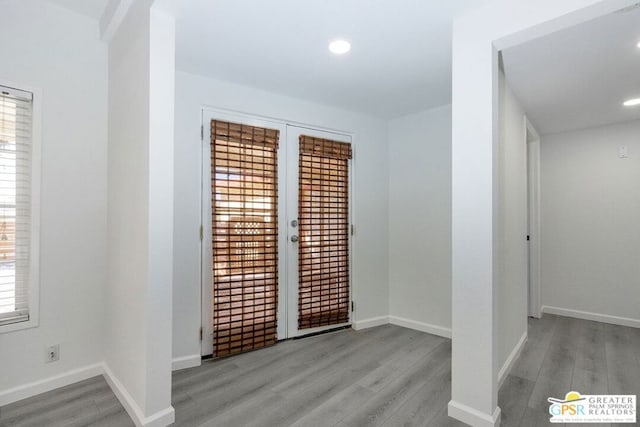 empty room featuring french doors and light hardwood / wood-style floors