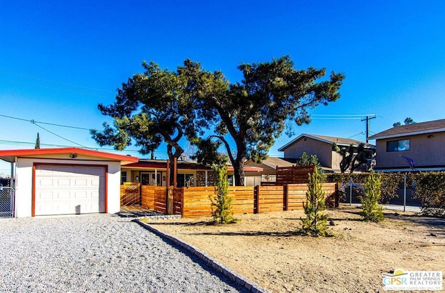 view of yard with a garage and an outbuilding