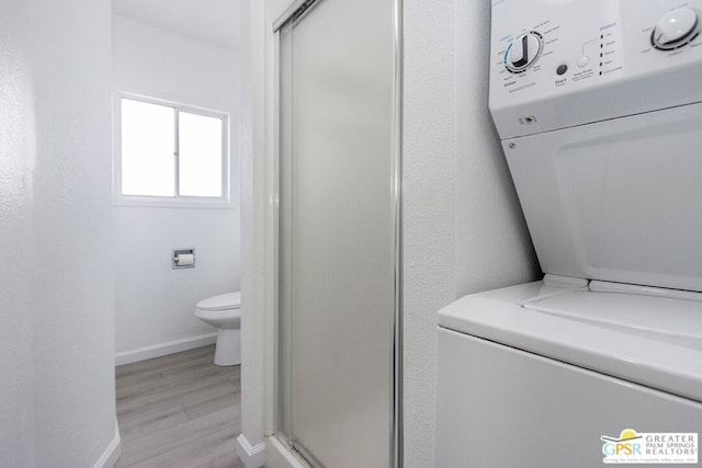 clothes washing area with light hardwood / wood-style floors