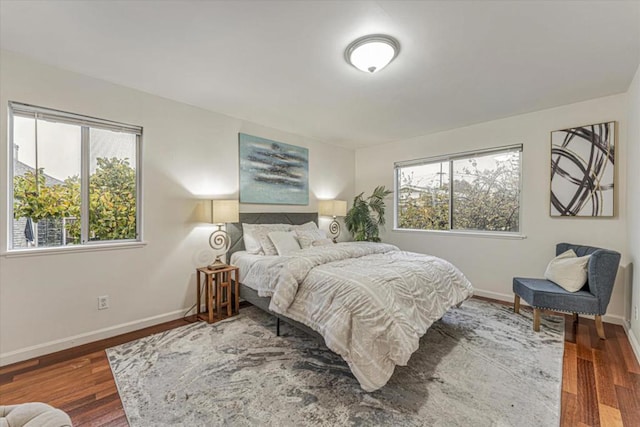 bedroom featuring dark hardwood / wood-style floors and multiple windows