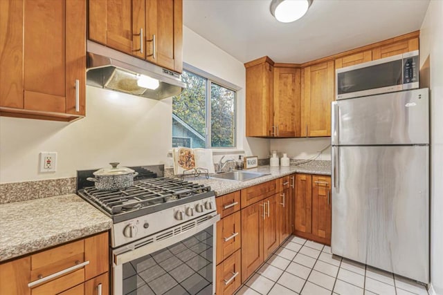 kitchen with light tile patterned flooring, appliances with stainless steel finishes, and sink