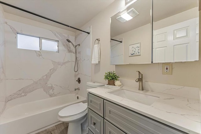 full bathroom with vanity, tiled shower / bath combo, and toilet