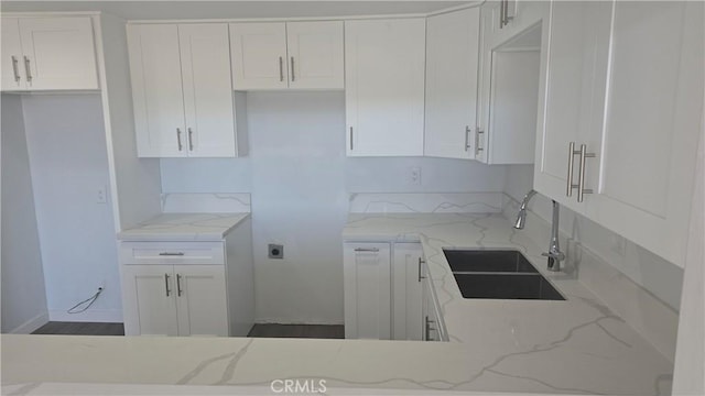 kitchen with light stone counters and sink